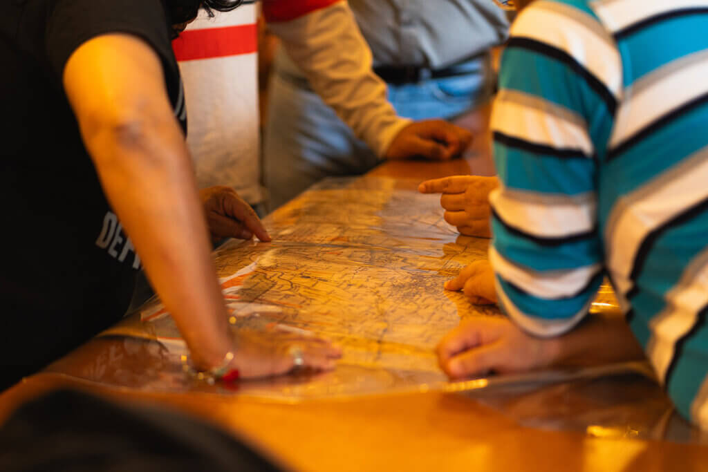 Teachers' hands on an old map