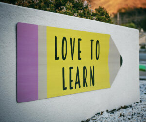 Sign with a pencil that says Love to Learn
